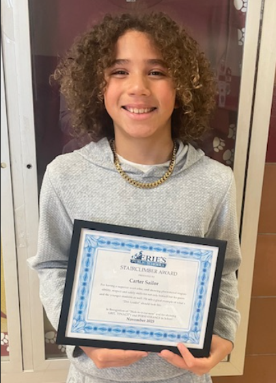 Carter Sailor, Grover's Stairclimber for December, poses with his award plaque.